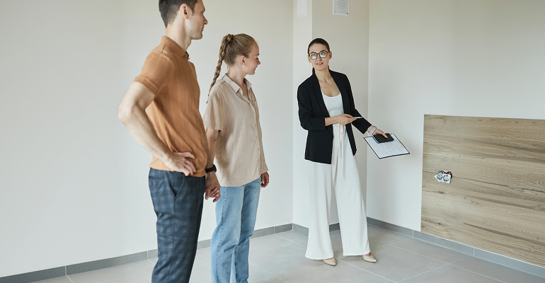 Property manager and owner discussing cost-effective tile cleaning instead of renovation