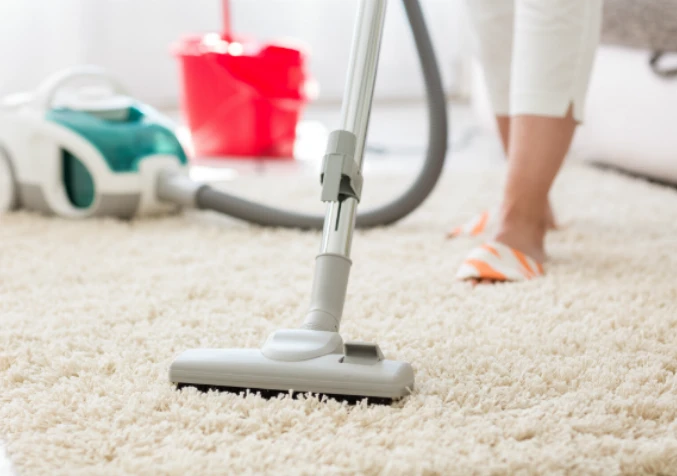 woman vacuuming carpet