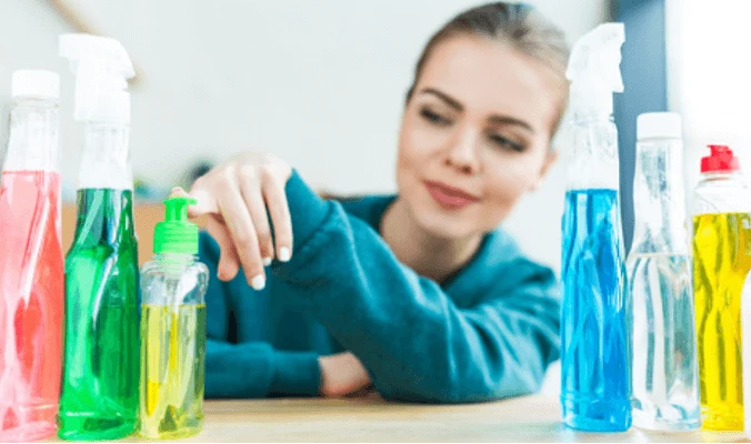 woman with assorted commercial cleaning products