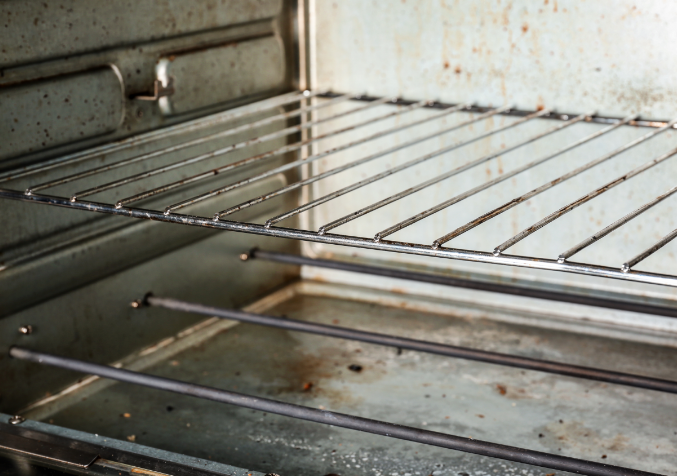 A Close Up shot of a Rusty and Dirt Oven