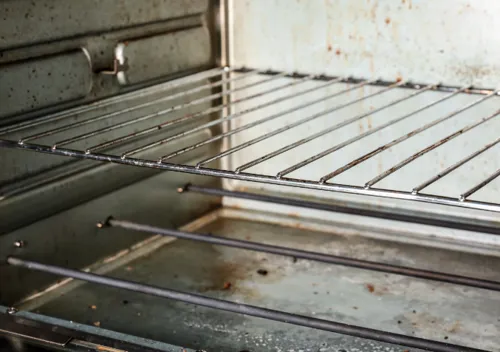 A Close Up shot of a Rusty and Dirt Oven
