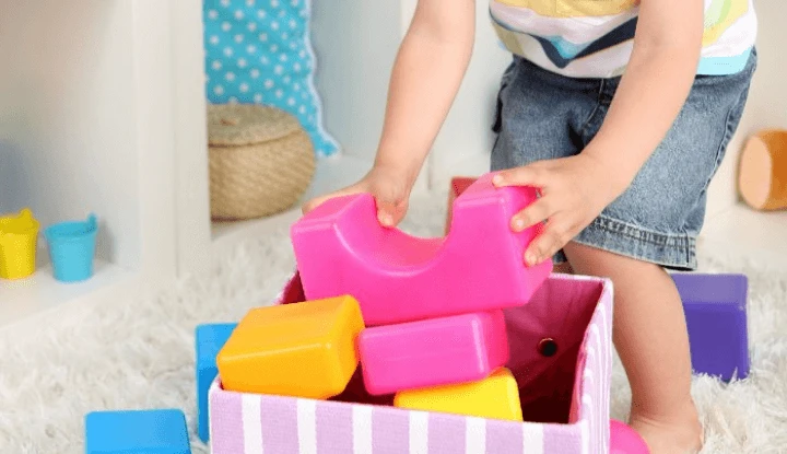 kid's hands picking-up toys