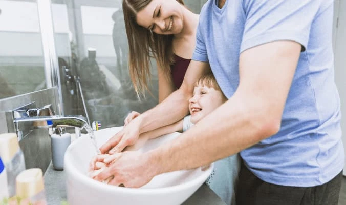 happy family washing hands together