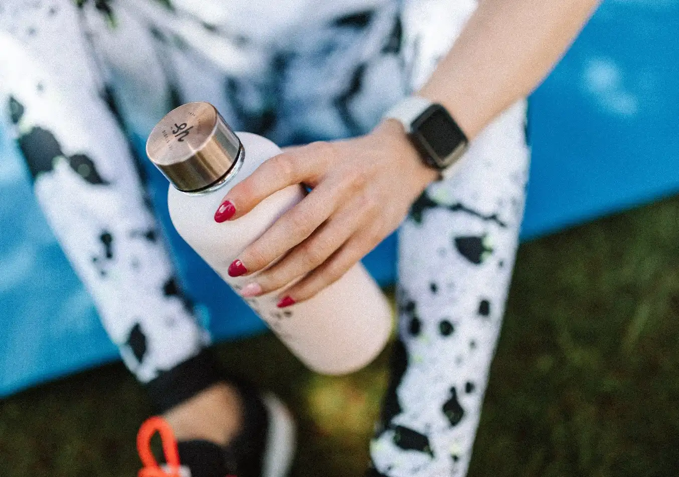 person carrying a water bottle after a workout