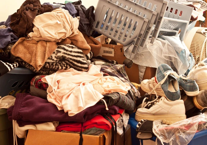 piles of clothes and shoes