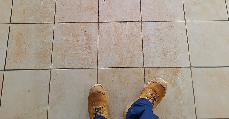 Discoloured grout in a rental property that routine cleaning cannot restore