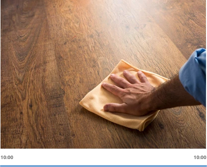 hand wiping wood floor