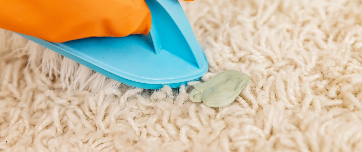 Close-up of chewing gum stuck on carpet.