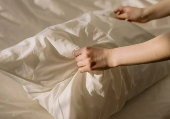 hand touching pillow