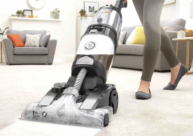 woman using carpet shampooer