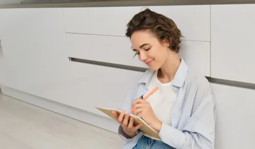 Person preparing checklist on the kitchen