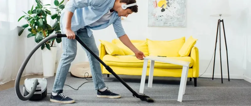 Homeowner cleaning living room carpet