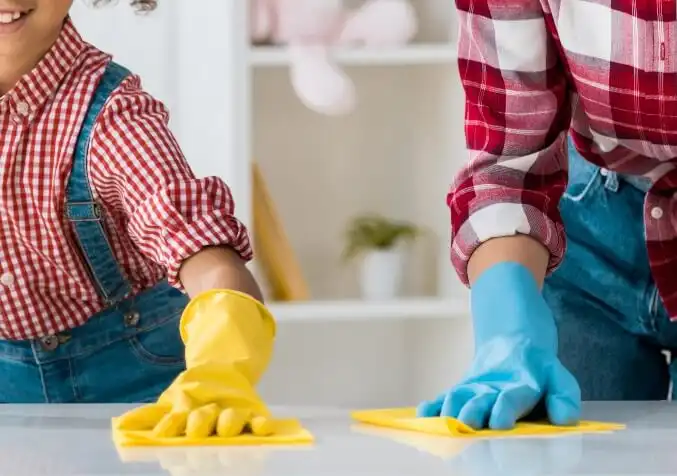 parent teaching child how to clean