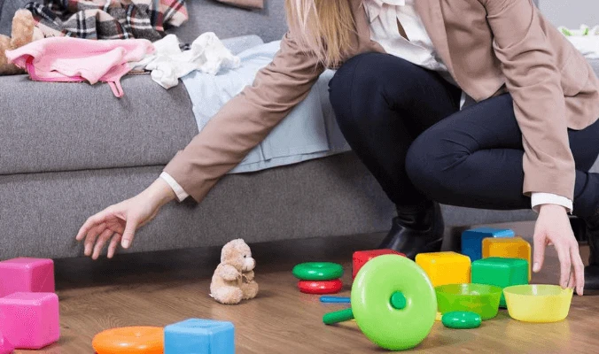 woman picking up toys