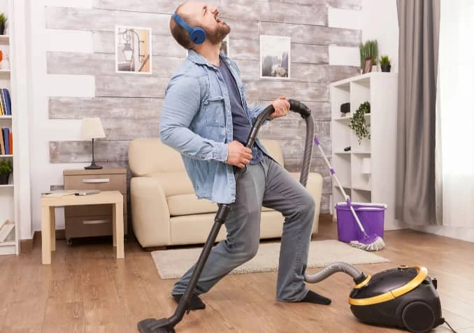 man cleaning while listening to music