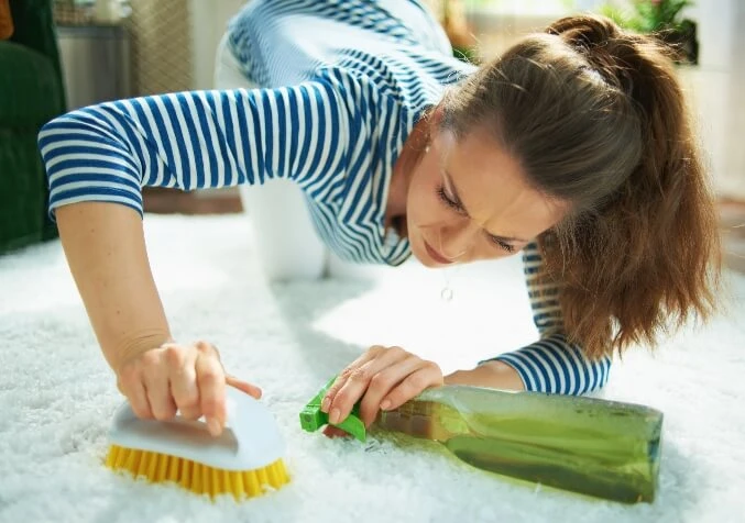 woman having a difficult time cleaning carpets on her own