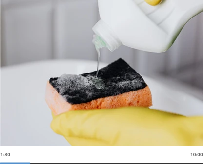 hand with sponge and cleaning solution
