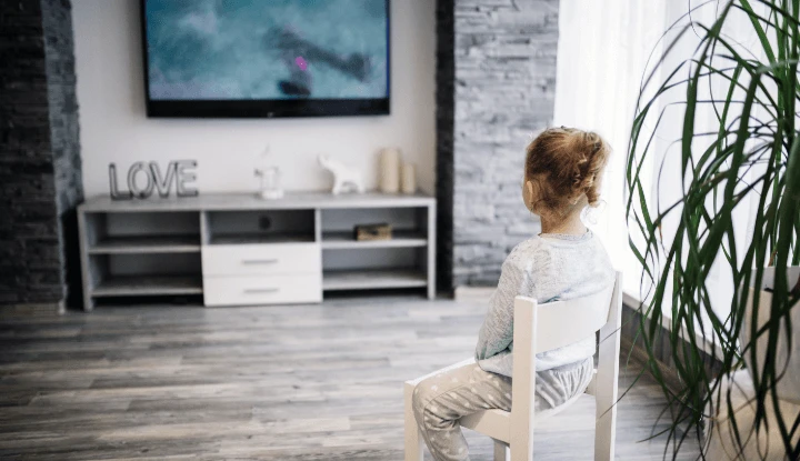 little girl sitting and watching tv