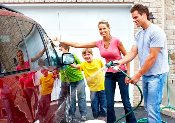 family washing car