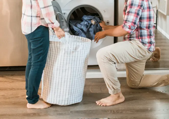 father and daughter doing laundry