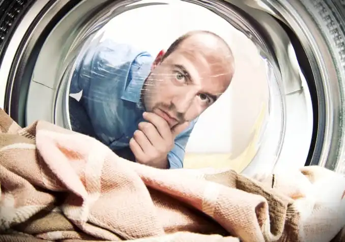 man confused in doing laundry