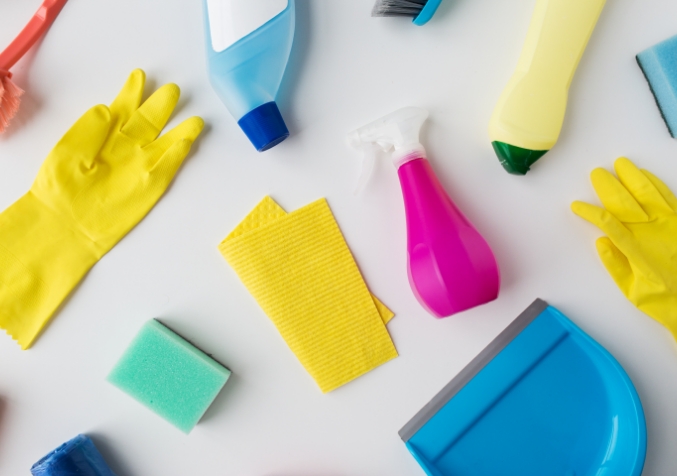 Rubbing alcohol, vinegar, detergent, and white cloths used to remove ink stains from a fabric sofa.
