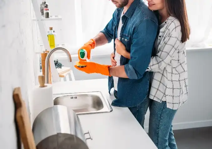 couple cleaning in the kitchen