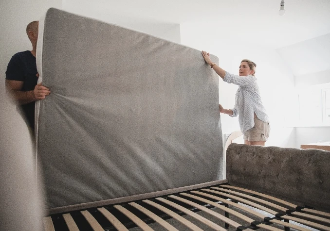 couple flipping mattress