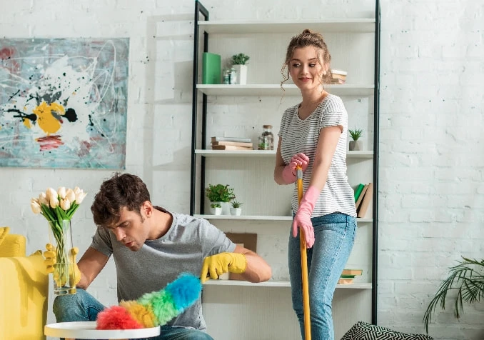 couple cleaning the house