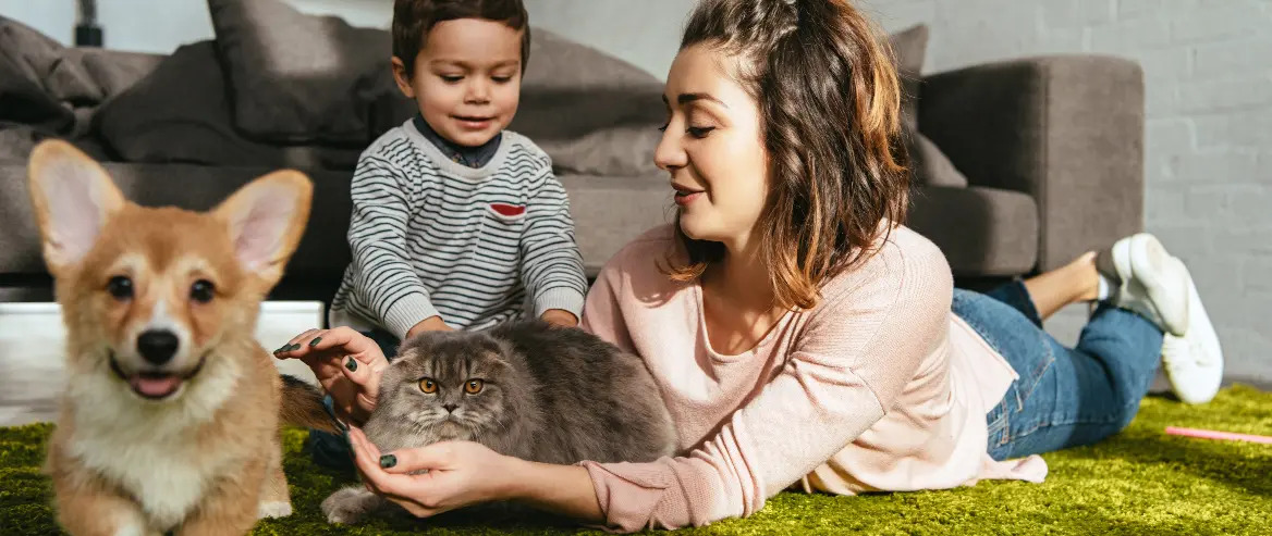 cat and dog on the floor with mom and toddler