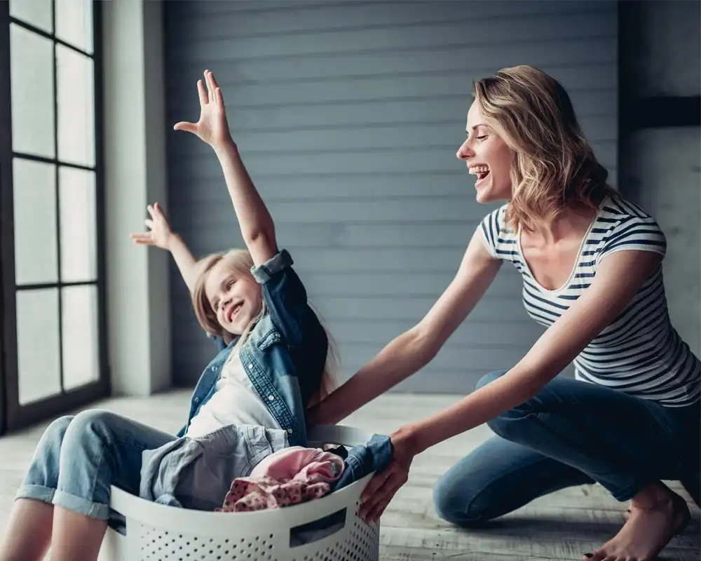 mom and daughter doing laundry