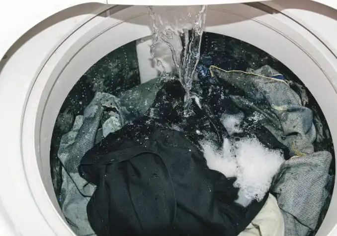 clothes being soaked inside a washing machine