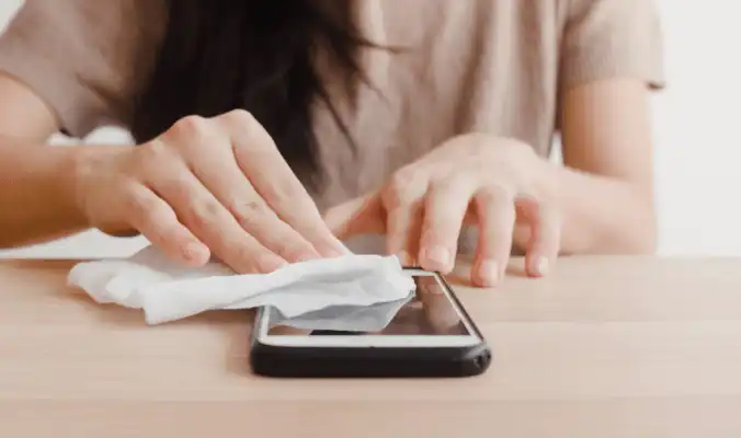 woman cleaning her phone screen