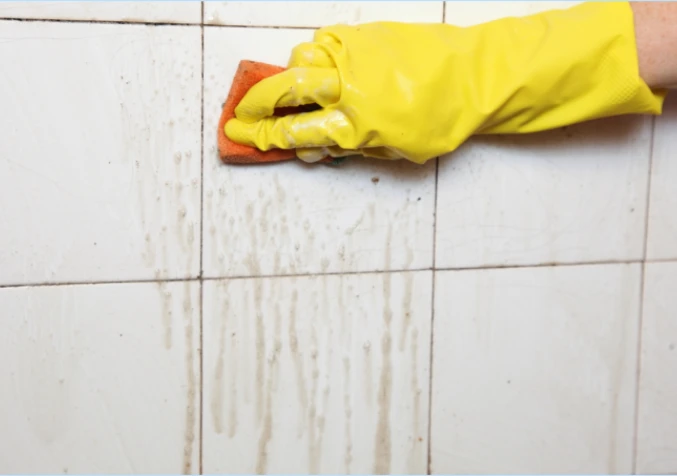 scrubbing bathroom walls with baking soda