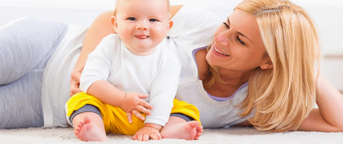 mother and child llying down on fresh clean carpet