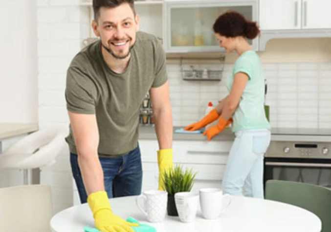 wiping table with disinfectant spray