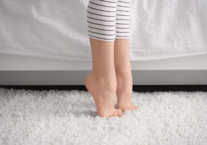 child tip toeing on clean dry carpets
