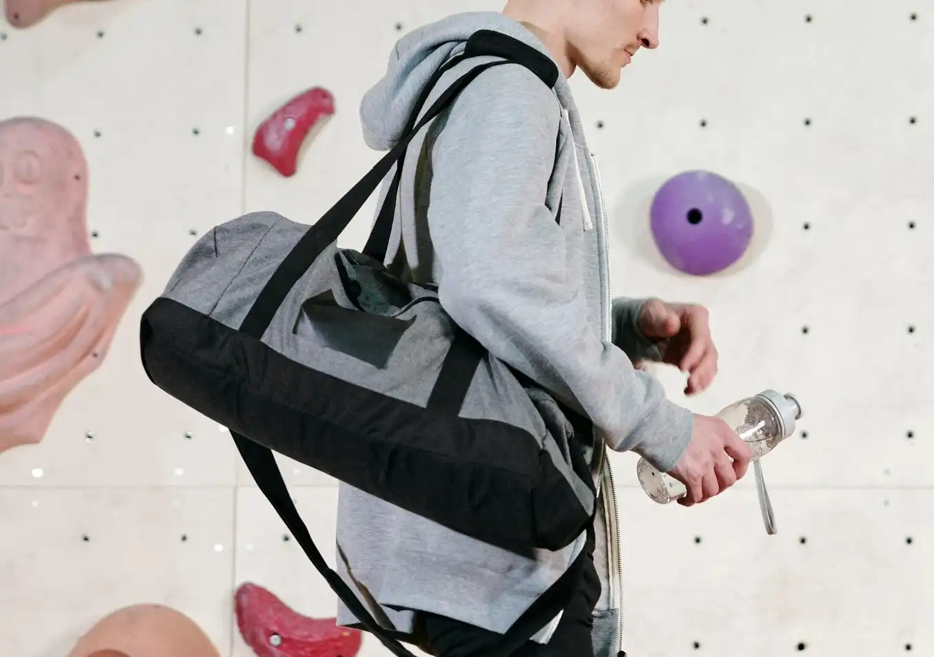 person carrying a gym bag for working out