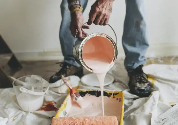 pouring paint to redecorate home