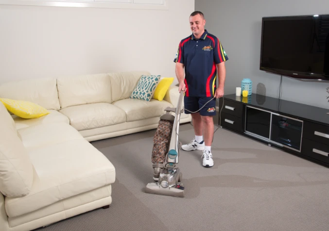 Electrodry technician vacuuming carpets