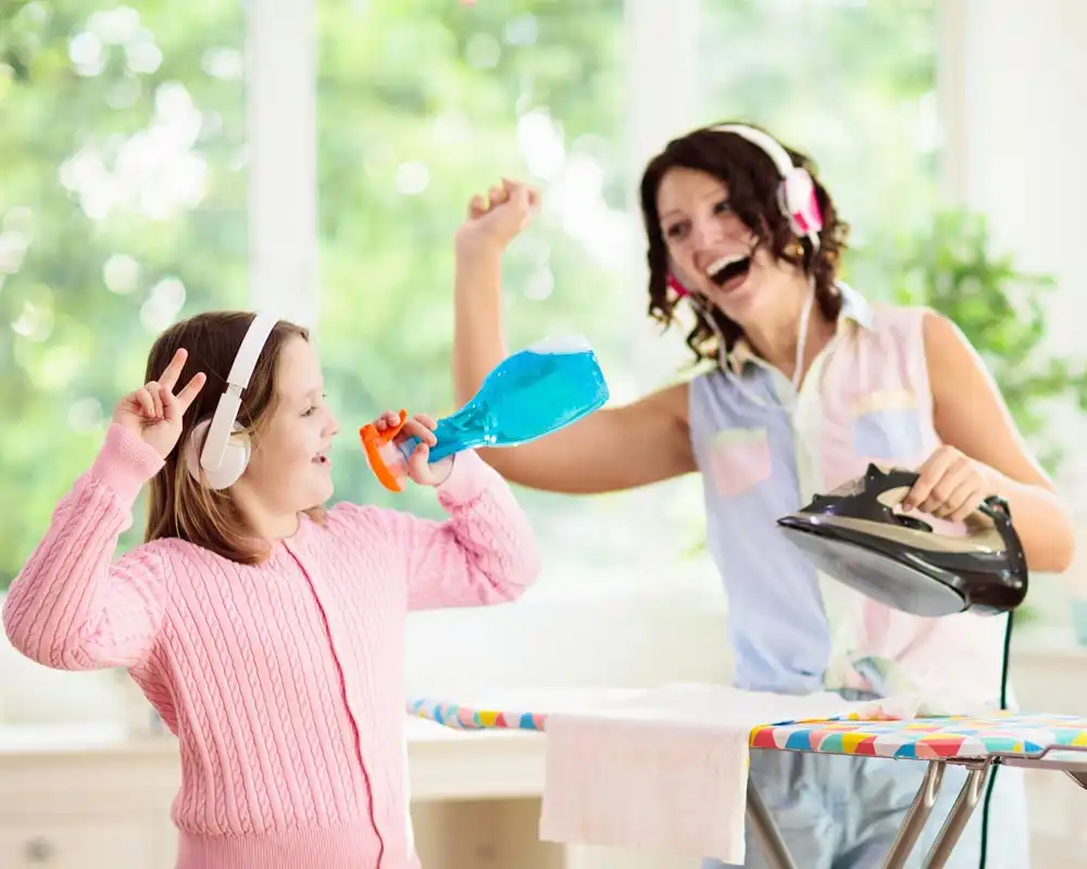 mom and daughter having fun while cleaning