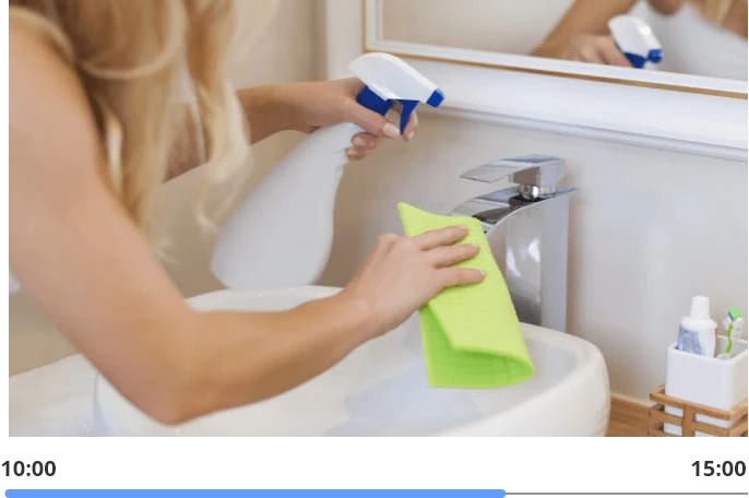 woman cleaning the bathroom faucet