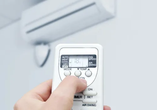 Air conditioner remote set to dry mode to reduce humidity and energy use.