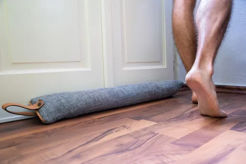 Closing blinds and sealing door gaps to keep cool air inside.