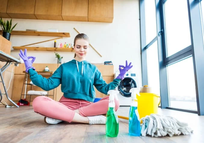 woman doing yoga while cleaning