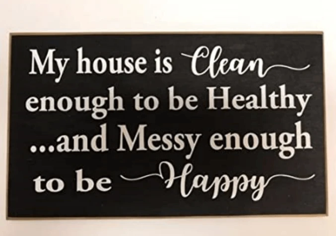 signage in a wall saying my house is clean enough to be healthy and messy enough to be happy