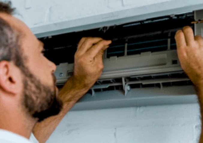 technician cleaning aircon filter