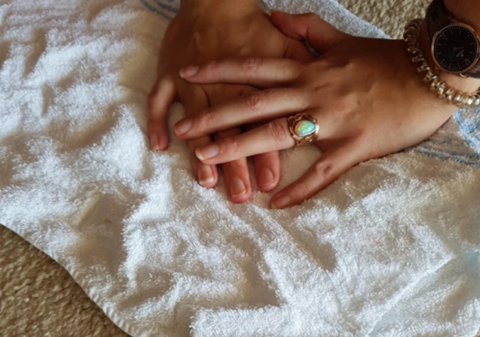 absorb the orange juice from the carpet using a clean white towel