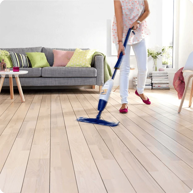 Woman Cleaning Wood Floor Using Bona Wood Floor Spray Mop