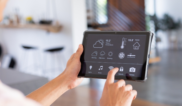Setting an air conditioner timer or smart control to manage cooling schedule efficiently.